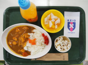 慶應日吉キャンパスで初開催された「子ども食堂」で提供されたカレーライス（チキン）やデザートなど。アクセントのにんじんは「イチョウ」や「星」など5種類。ナプキンにも校章が入り慶應らしいアレンジに（12月17日）